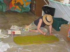 Mary Anne Magy painting the three little pigs.